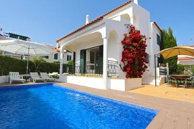 a villa with a swimming pool and a house at Villa Amelia 156 - Clever Details in Vilamoura