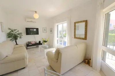 a living room with two white couches and a tv at Villa Amelia 156 - Clever Details in Vilamoura