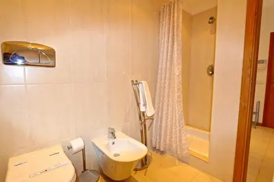 a bathroom with a white toilet and a sink at Villa Gustas 150 - Clever Details in Vilamoura