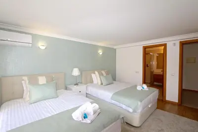 a bedroom with two beds with towels on them at Villa Gustas 150 - Clever Details in Vilamoura
