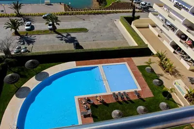 an overhead view of a swimming pool in front of a building at Aquamar Sea View - Clever Details in Vilamoura