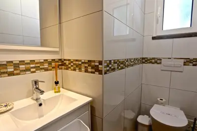 a bathroom with a sink and a toilet and a mirror at Villa Caroline 3 - Clever Details in Vilamoura