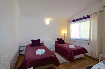 a bedroom with two beds and a window at Villa Caroline 3 - Clever Details in Vilamoura