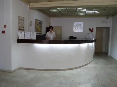 a woman standing at a counter in a room at Mirachoro Albufeira in Albufeira
