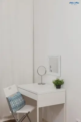 a white room with a bed and a table at Palma's Place in Faro