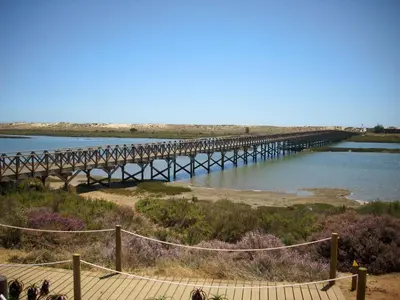 a bridge over a river next to a body of water at Victory Village T1 & Mezzanine in Quinta do Lago