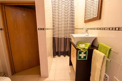 a bathroom with a sink and a toilet and a mirror at Sergio s Place - FARM VILLAGE - By Algarkasa in Albufeira