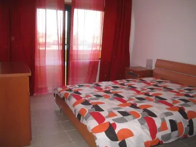 a bedroom with a bed with a colorful comforter at Apartamento golf-mar in Vilamoura