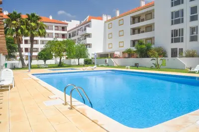 a swimming pool in front of a building at Beach House in Vilamoura: Terrace+pool in Vilamoura