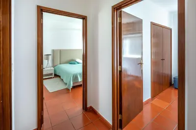 a mirror in a room with a bedroom at Quinta Golf & Beach House in Quinta do Lago