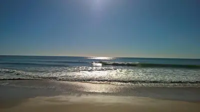 a boat is in the water on the beach at Luxurious T2 apartment, Olhos Dagua in Albufeira
