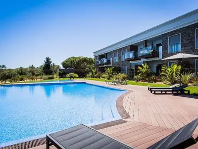 a large swimming pool in front of a building at Luxurious T2 apartment, Olhos Dagua in Albufeira