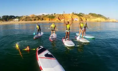 a group of people on paddle boards in the water at Luxurious T2 apartment, Olhos Dagua in Albufeira