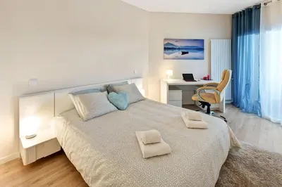 a bedroom with a large bed with two towels on it at Luxurious T2 apartment, Olhos Dagua in Albufeira