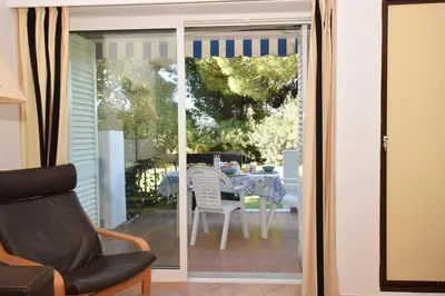 a sliding glass door leading to a patio with a table at Casa Flor in Vilamoura