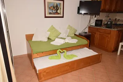 a bedroom with a bed with two stuffed animals on it at Casa Flor in Vilamoura
