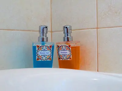 two bottles ofodorizers sitting on top of a sink at Villa Esmeralda in Albufeira