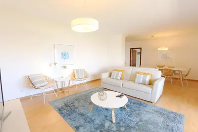 a living room with a white couch and a table at Indico 154 - Clever Details in Vilamoura