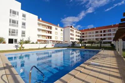 a swimming pool in front of a building at Indico 154 - Clever Details in Vilamoura