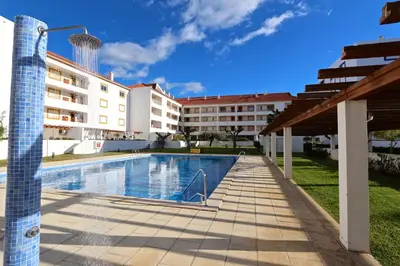 a swimming pool in front of a building at Indico 154 - Clever Details in Vilamoura