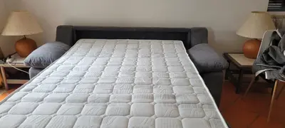a bed in a living room with two tables and a bed sidx sidx at Apt P209 situé au sein de Balaia Golf Village in Albufeira