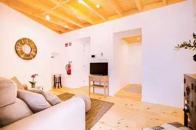 a living room with a couch and a tv at A Casa D'Amelie in Faro