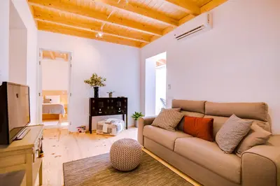 a living room with a couch and a tv at A Casa D'Amelie in Faro