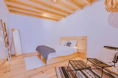 a bedroom with a bed and a wooden ceiling at A Casa D'Amelie in Faro