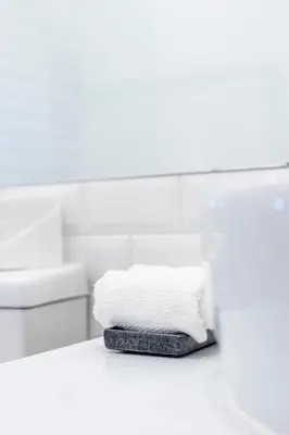 a stack of towels on a counter in a bathroom at Ria Beach House in Faro