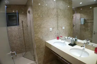 a bathroom with two sinks and a shower at Villa Margarida by Laranjal Rentals in Albufeira