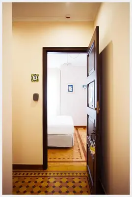 a door leading to a bedroom with a bed at Senhor Gigi in Faro