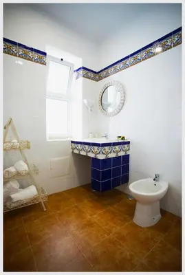 a blue and white bathroom with a sink and a toilet at Senhor Gigi in Faro