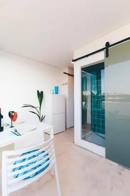 a room with a white table and a window at Studio Sal in Albufeira