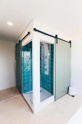 a shower stall with a glass door in a room at Studio Sal in Albufeira