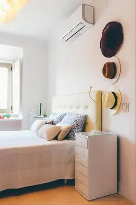 a bedroom with a bed with a white headboard at Studio Sal in Albufeira