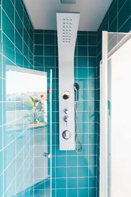 a blue tiled bathroom with a shower at Studio Sal in Albufeira