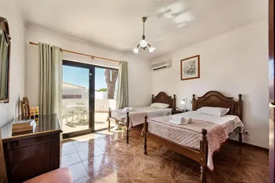 a room with a pool table and a refrigerator at Residential cul-de-sac walking distance to centre, private pool, free AC wifi in Loulé