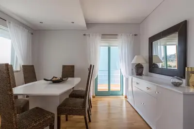 a dining room with a table and chairs and a window at SeaShell Apartment by Atlantic Places in Albufeira