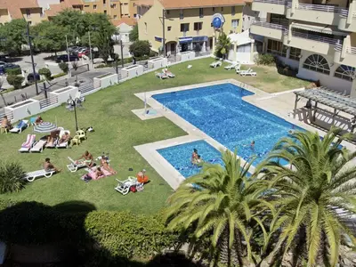 an overhead view of a pool with people laying on the grass at Seastar in Vilamoura