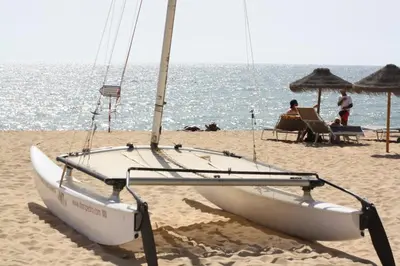 a sail boat on the beach with people on the beach at Seastar in Vilamoura