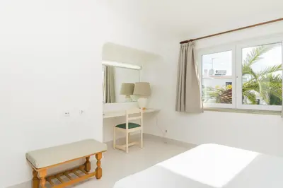 a white room with a desk and a window at Great S.Rafael Aprt. walking distance to the beach in Albufeira