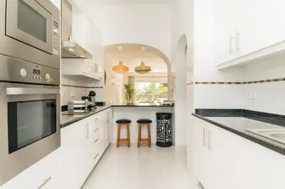 a white kitchen with a sink and a counter at Great S.Rafael Aprt. walking distance to the beach in Albufeira