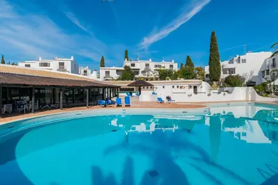 a large swimming pool with blue water in front of a building at Great S.Rafael Aprt. walking distance to the beach in Albufeira