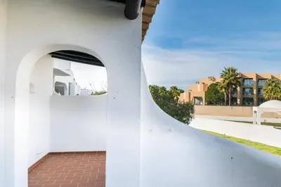 a building with a white wall and a brick walkway at Great S.Rafael Aprt. walking distance to the beach in Albufeira