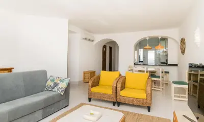 a living room with a couch and chairs and a table at Great S.Rafael Aprt. walking distance to the beach in Albufeira