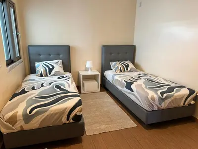 two beds sitting next to each other in a bedroom at Brisa do Mar - 2BR Sea Front Luxury Apartment in Quarteira