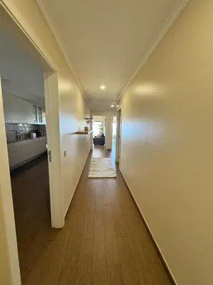 a hallway leading to a kitchen in a house at Brisa do Mar - 2BR Sea Front Luxury Apartment in Quarteira