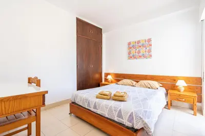 a bedroom with a bed with two towels on it at Edifício Sequeira - Alojamento Local by Umbral in Albufeira