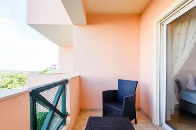 a balcony with two chairs and a window at Quinta do Paiva - Jardins do Vale in Roja- Pé