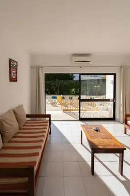 a living room with a couch and a table at Eirasol by Umbral in Albufeira